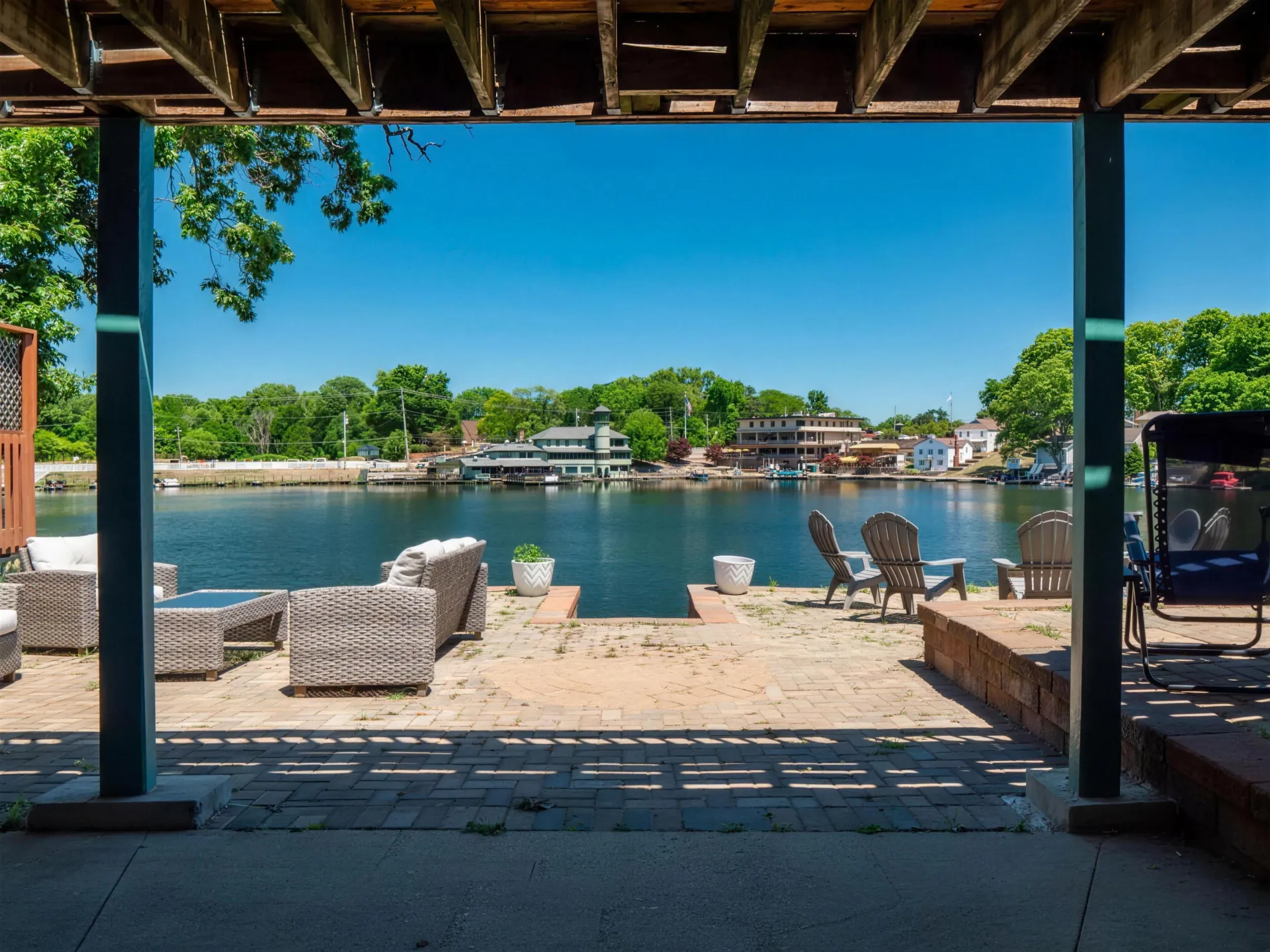 A HomeHop lakefront patio with lounge chairs looking out over the water