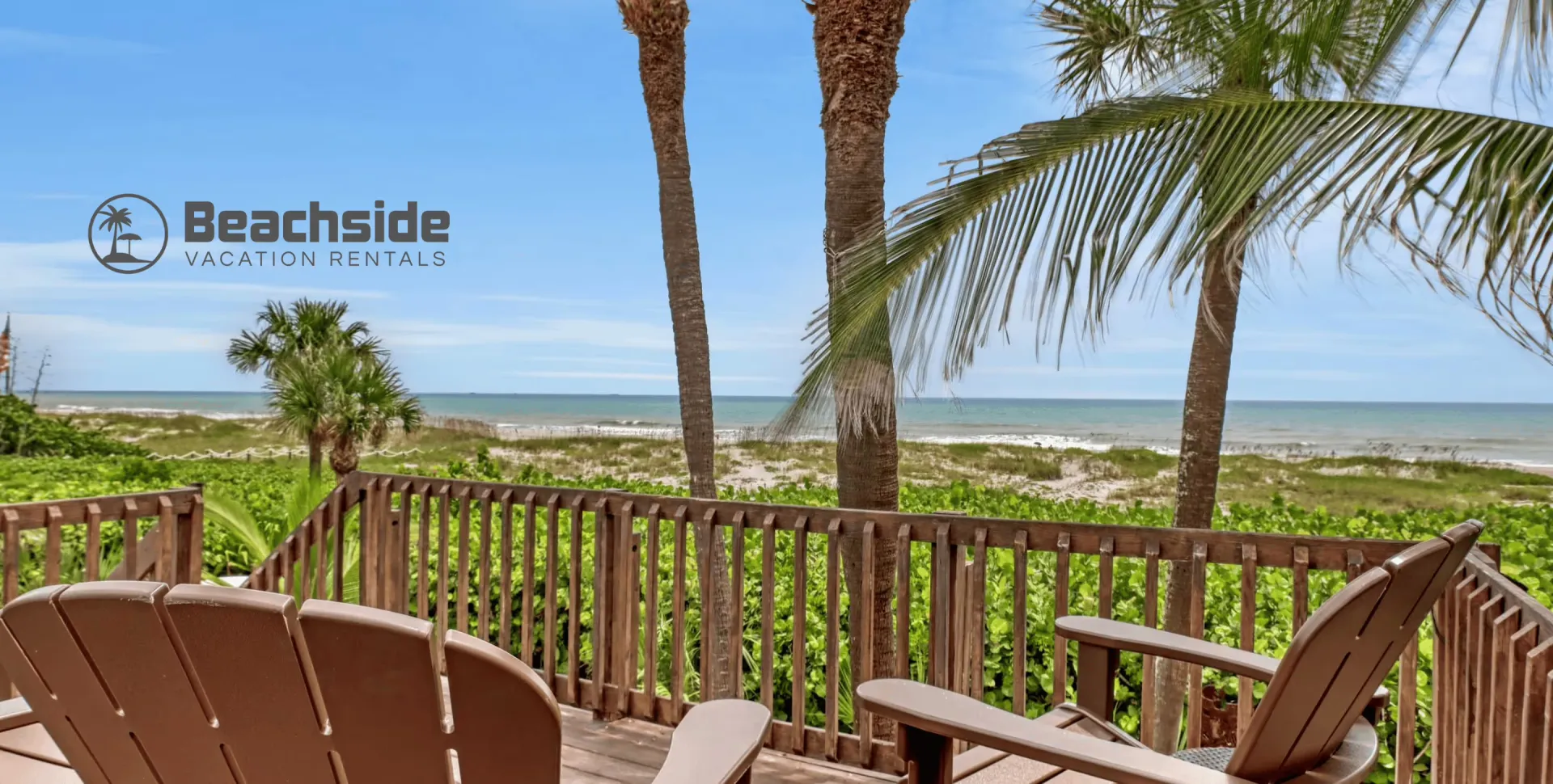 Adirondack chairs on a beachfront deck at a Beachside Vacation Rentals home in Cocoa Beach, Florida